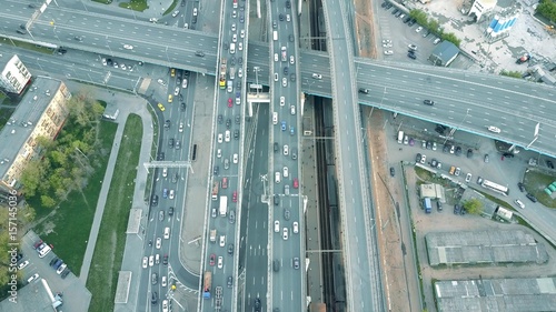 Fotografie Aerial shot of traffic jam on a highway and moving train in the rush hour