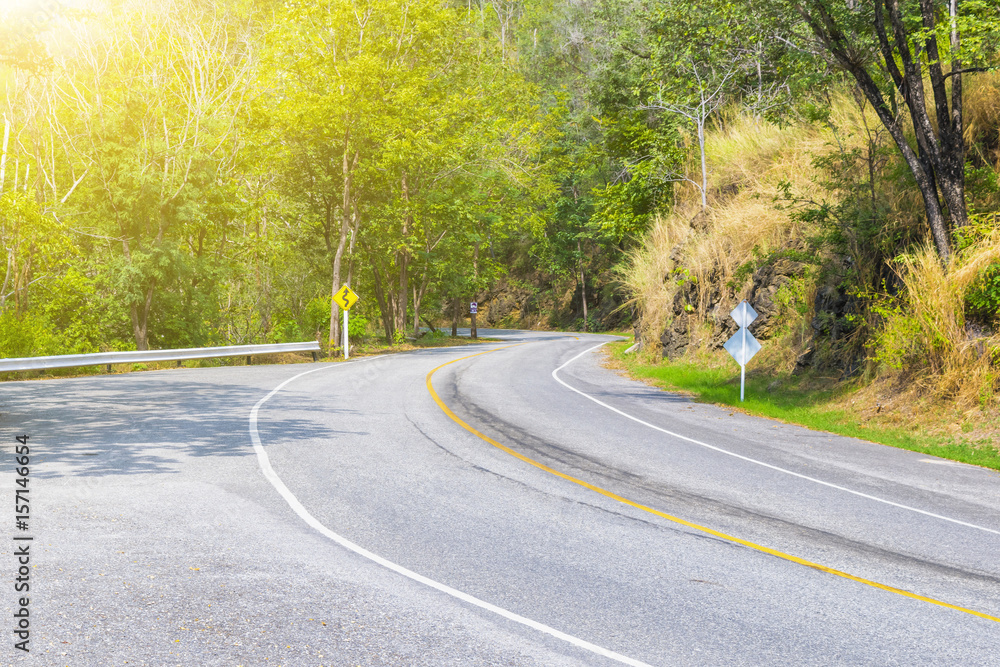 Fototapeta premium The road in the park with many tree beside with lighting