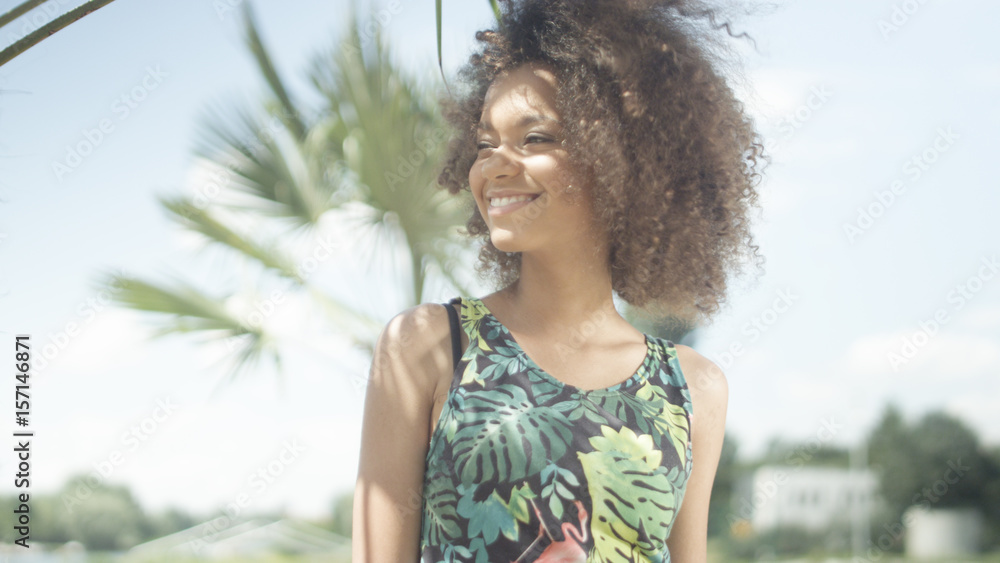 Young Afro American girl enjoying time on tropical beach. Beautiful young woman posing to a camera. Young Afro American girl enjoying time on tropical beach. Beautiful young woman posing to a camera.