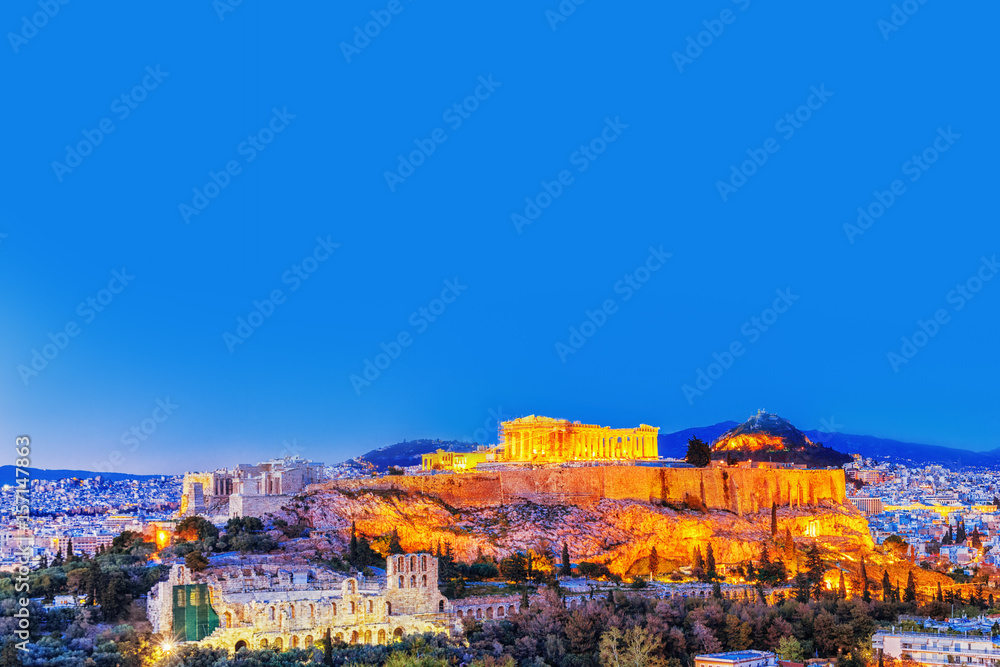 Parthenon and Herodium construction in Acropolis Hill in Athens, Greece. Twilight scenery.