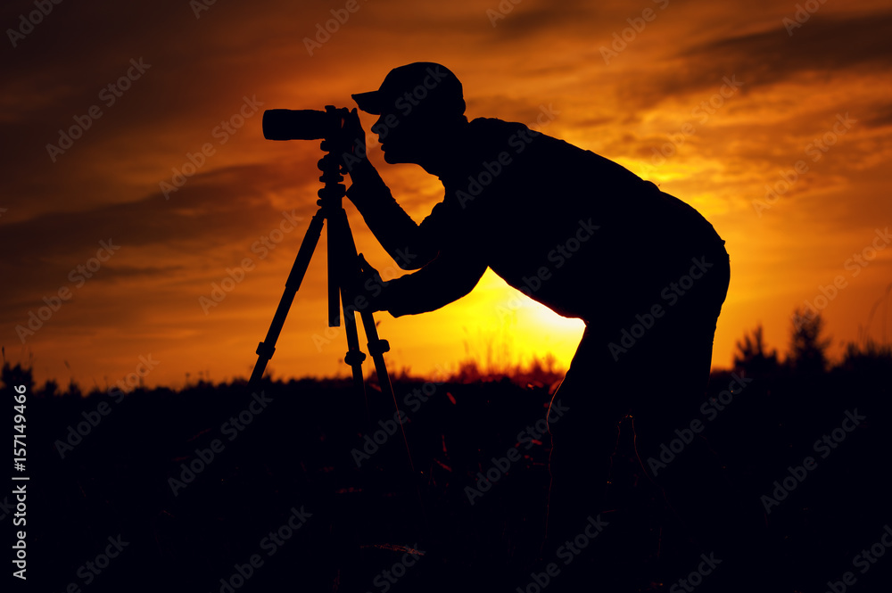 Silhouette of male photographer taking picture