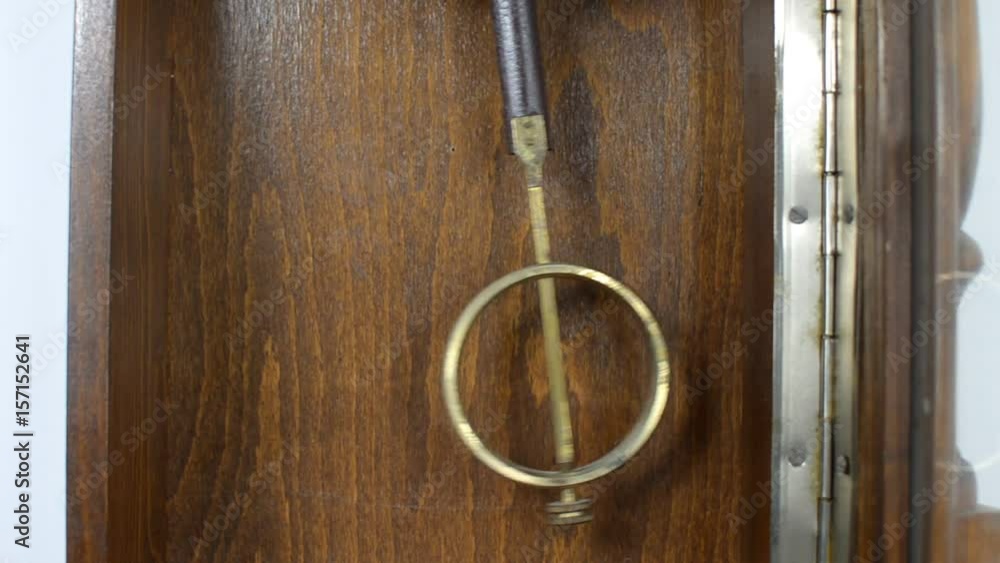 Close-up of swaying pendulum of a clock in a retro style Close-up of swaying pendulum of a clock in a retro style