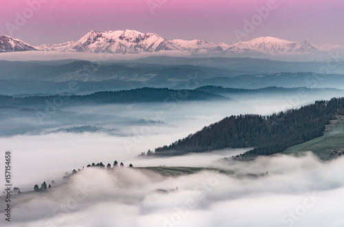 Beautiful spring panorama over misty Spisz highland to snowy Tatra mountains in the morning  Poland