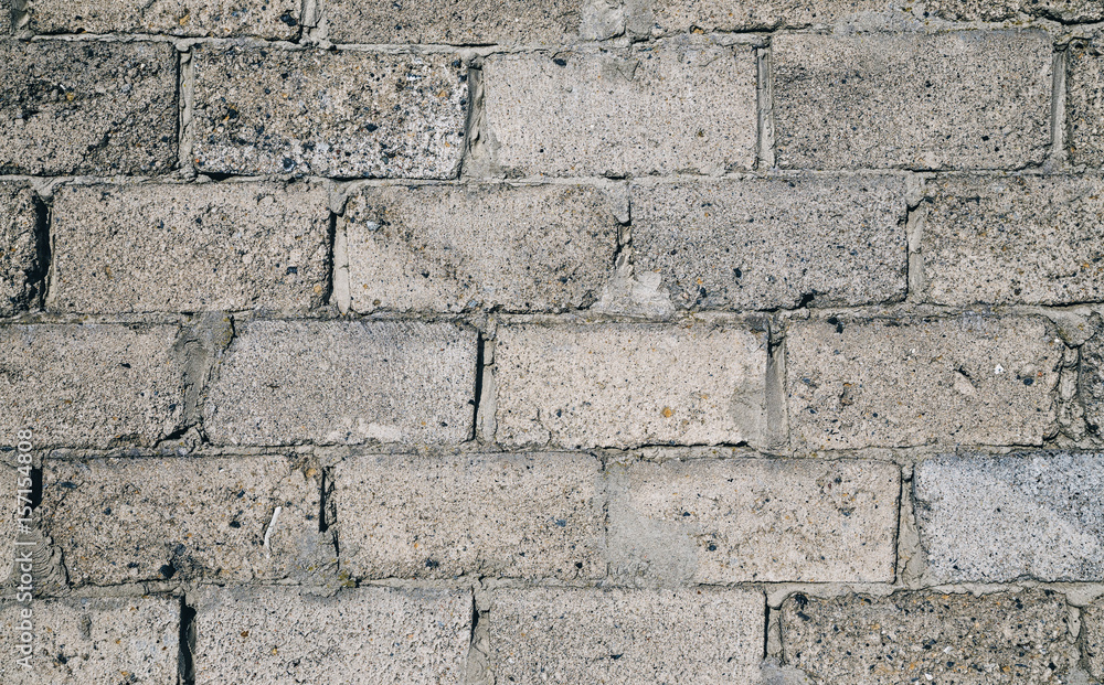 Fototapeta premium Empty wall of gray slag blocks. Brick background.
