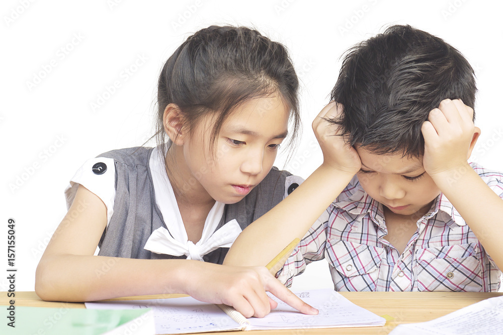 Sister try to teach her naughty younger brother to do homework isolated over white background Sister try to teach her naughty younger brother to do homework isolated over white background