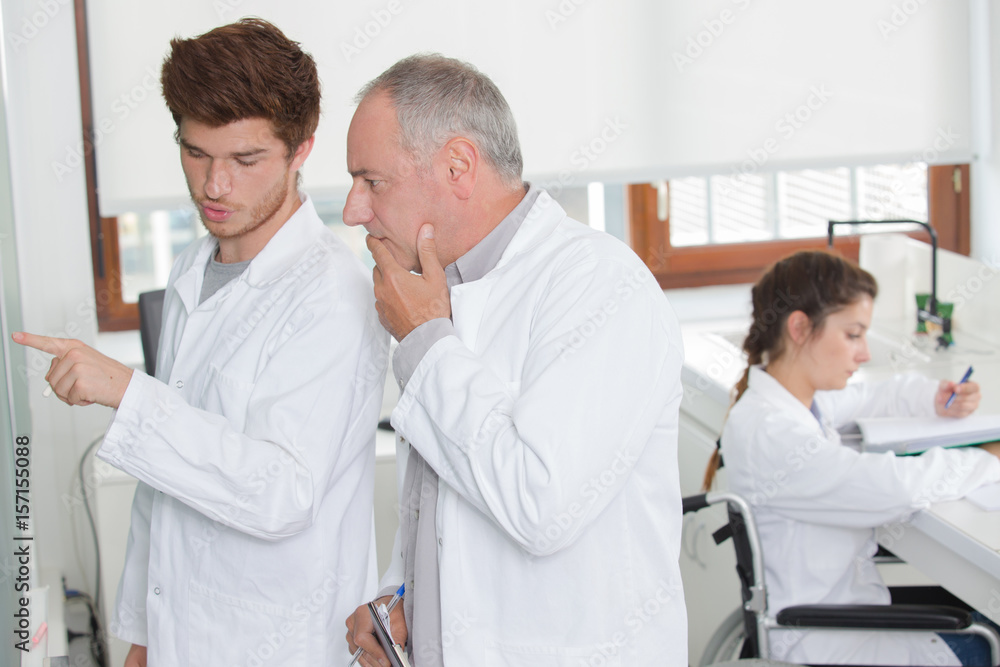 Fototapeta premium Science class, girl in wheelchair