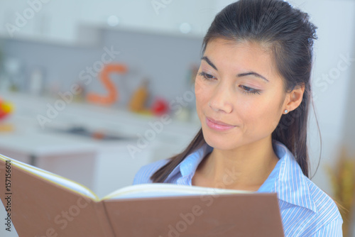 Woman at home reading at book