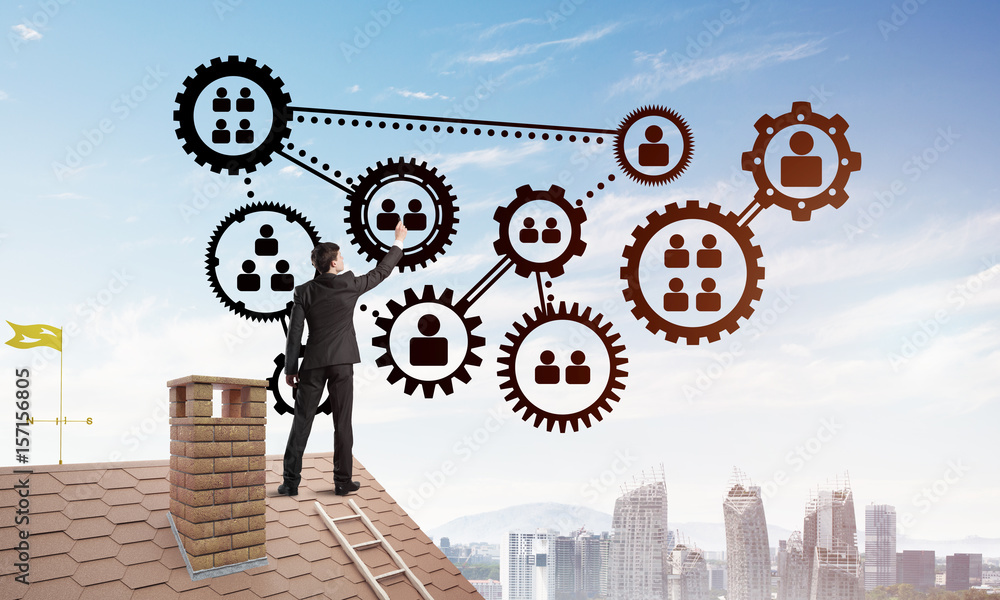 Businessman on house roof presenting teamwork and connection concept. Mixed media Businessman on house roof presenting teamwork and connection concept. Mixed media