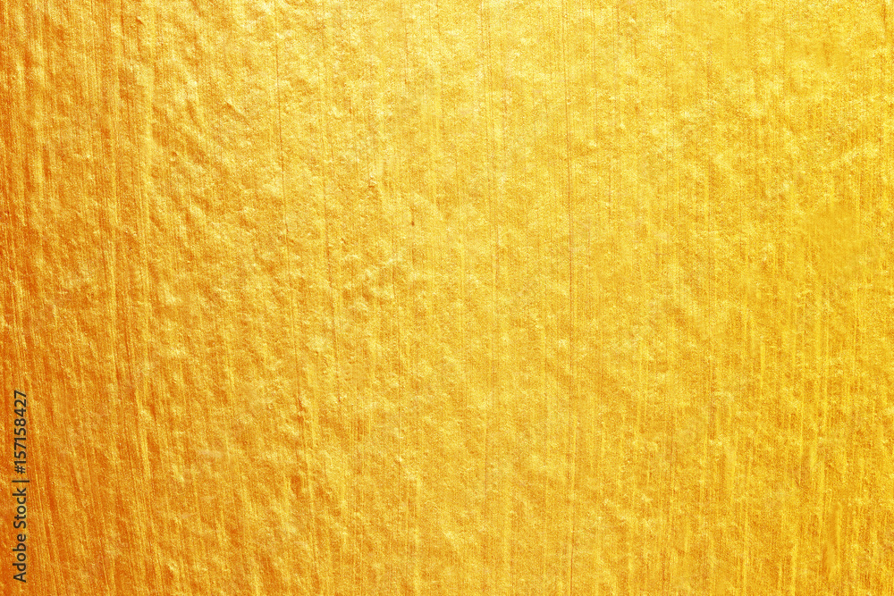 Fototapeta premium Gold paint on cement wall texture. golden texture background