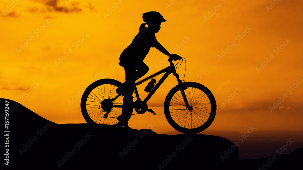 Girl cycling at mountain twilight time