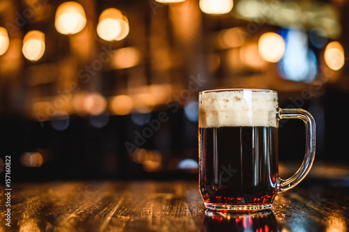 A glass of dark beer on counter