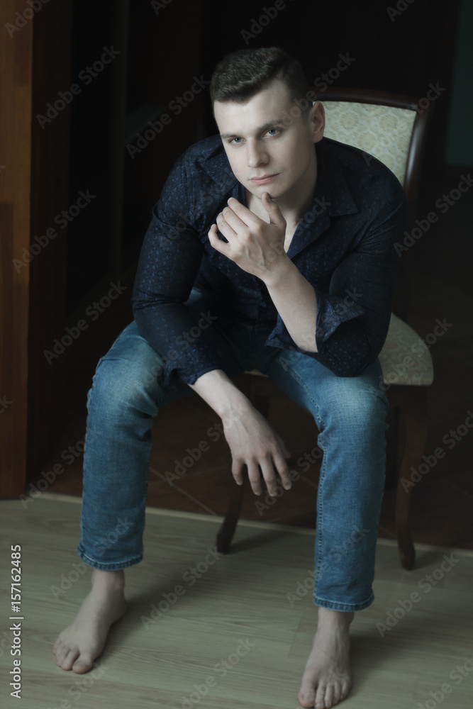 Young man full length studio low-key lighting dark portrait Young man full length studio low-key lighting dark portrait