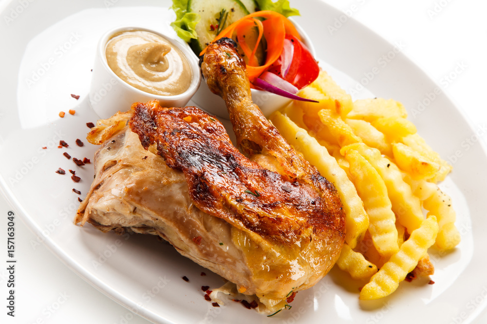 Roast chicken leg with french fries on white background Roast chicken leg with french fries on white background