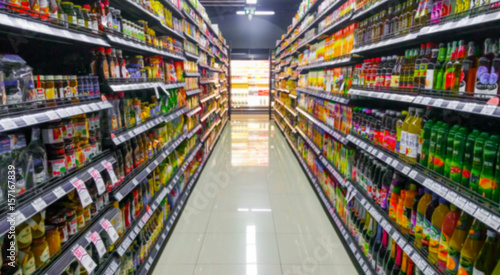 Blurred Background Abstract Bokeh Shelving unit in Shopping store supermarket look at the lights .