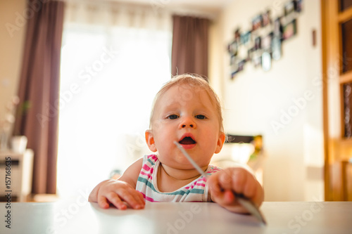 Adorable baby girl standing at home