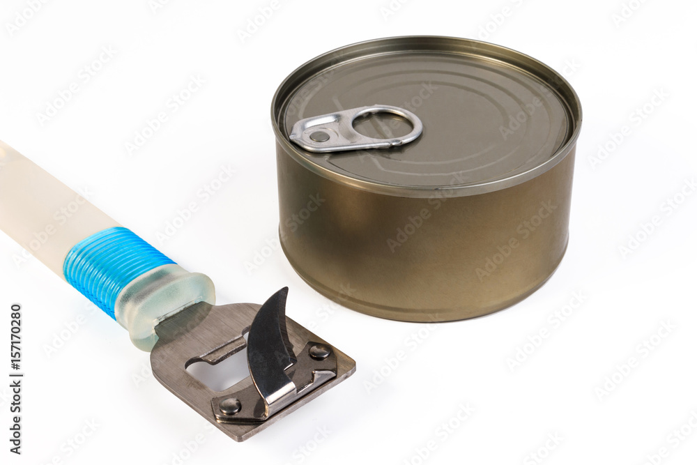 One can and can opener on white background. One shiny food tin can with no label and can opener isolated on white. One can and can opener on white background. One shiny food tin can with no label and can opener isolated on white.