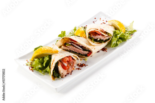 Spring rolls - wraps with meat and vegetables on white background 