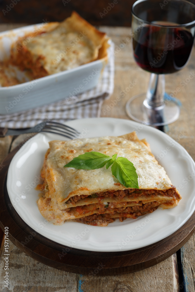 Lasagna Bolognese on a rustic table Lasagna Bolognese on a rustic table