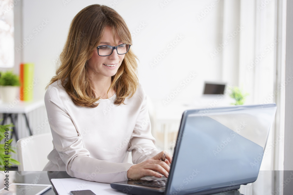 Financial advisor. Shot of a middle aged financial assistant businesswoman working laptop in the office. Financial advisor. Shot of a middle aged financial assistant businesswoman working laptop in the office.