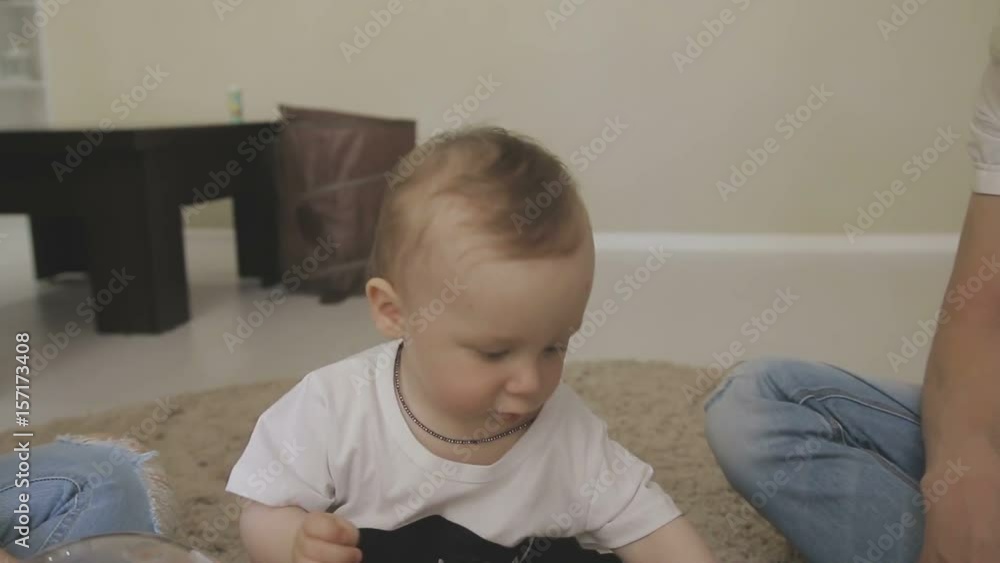 Father and mother are playing with their little child. Family at home Father and mother are playing with their little child. Family at home
