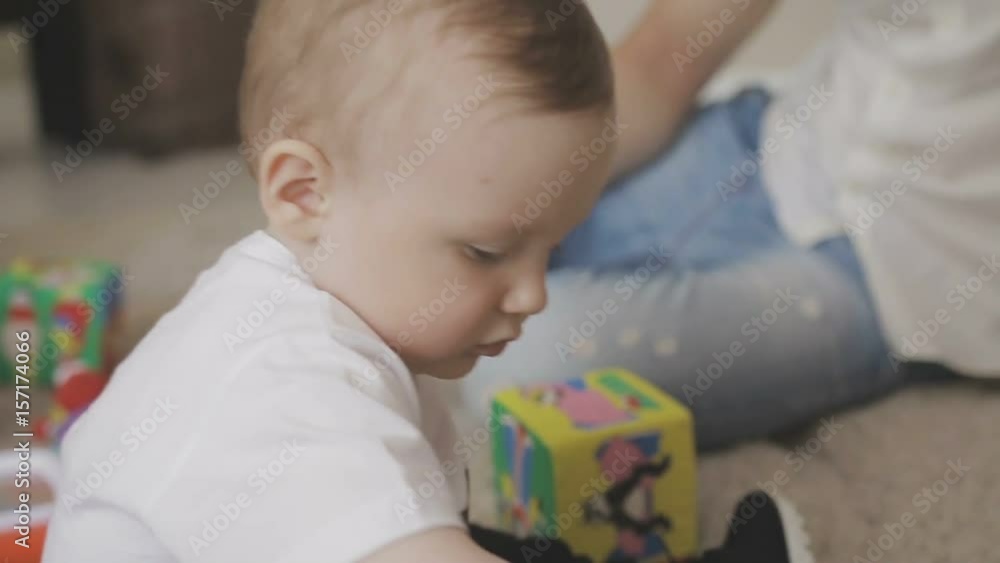 Father and mother are playing with their little child. Family at home Father and mother are playing with their little child. Family at home