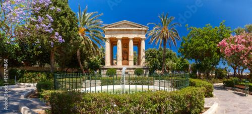 Panorama of blossoming spring Lower Barrakka Gardens and monument dedicated to Alexander Ball in the old town Valletta, capital of Malta.
