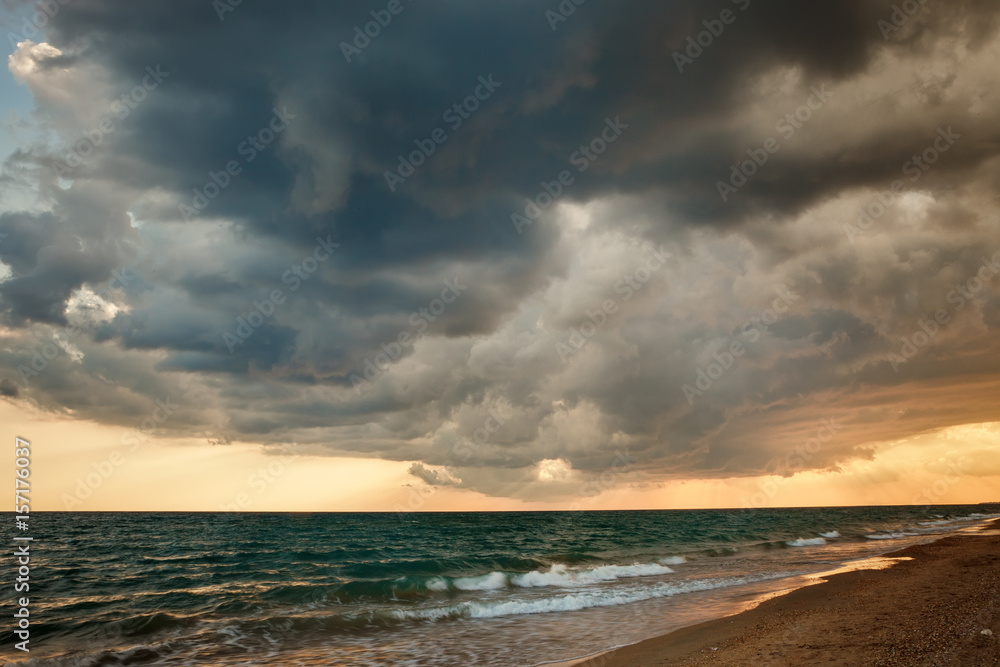 Obraz premium Fiery orange sunset sky. Beautiful sky.Beautiful flaming orange sunset with dark clouds above the sea.