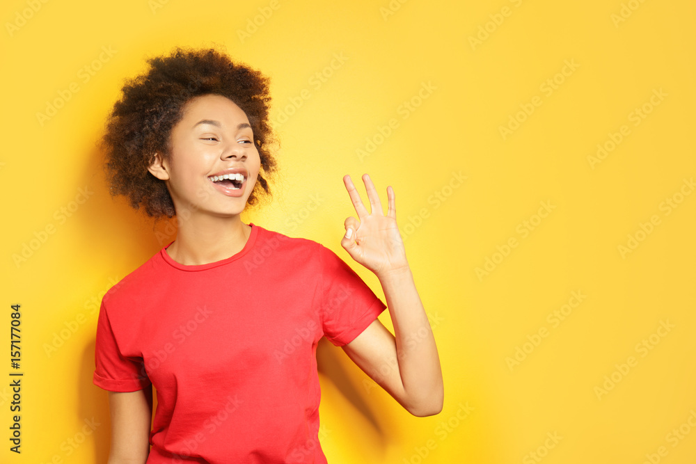 Beautiful African girl on yellow background Beautiful African girl on yellow background