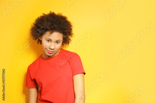 Beautiful African girl on yellow background
