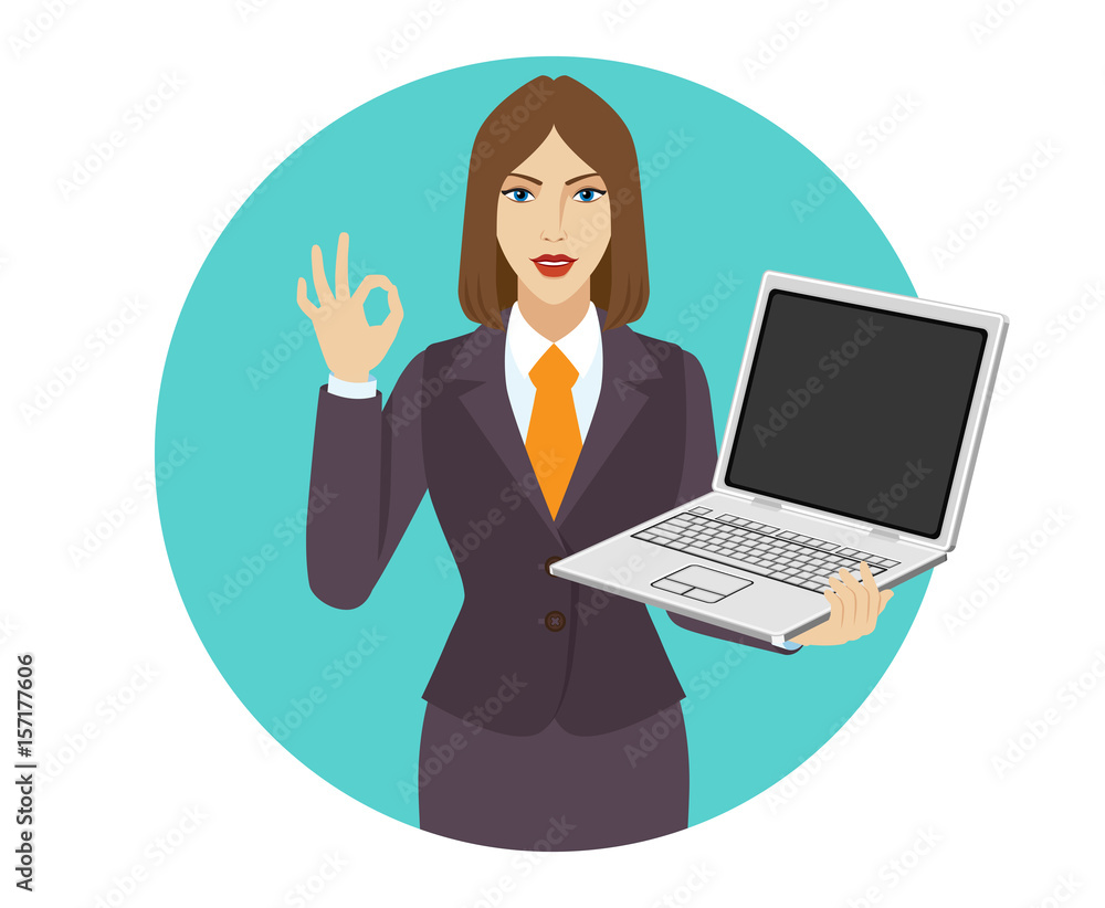 Businesswoman holding a laptop notebook and showing a okay hand sign Businesswoman holding a laptop notebook and showing a okay hand sign