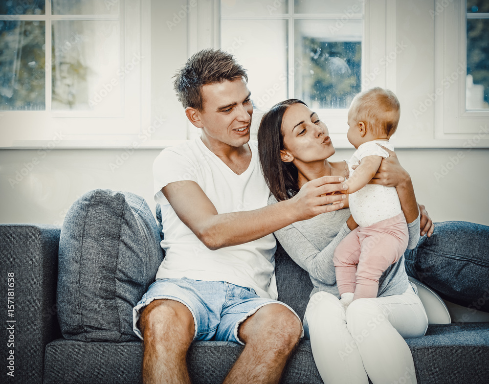 Happy couple with baby child.