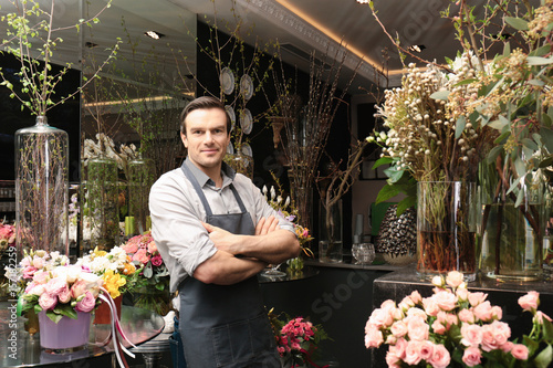 Handsome florist in flower shop photo