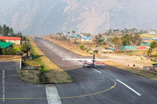 Tenzing–Hillary Airport in Lukla, the most dangerous airport in the world. A small plane is taking off. Sagarmatha National Park, Solukhumbu District in Nepal, Asia. 