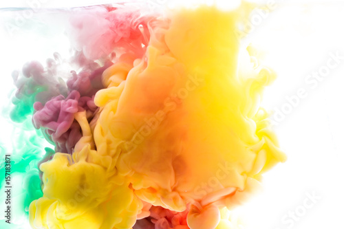 Yellow, blue, aquamarine, pink, green acrylic colors. Ink swirling in water. Color explosion