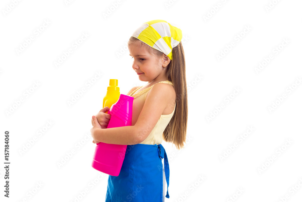 Girl in apron holding two bottles Girl in apron holding two bottles
