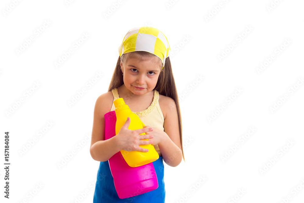Girl in apron holding two bottles Girl in apron holding two bottles