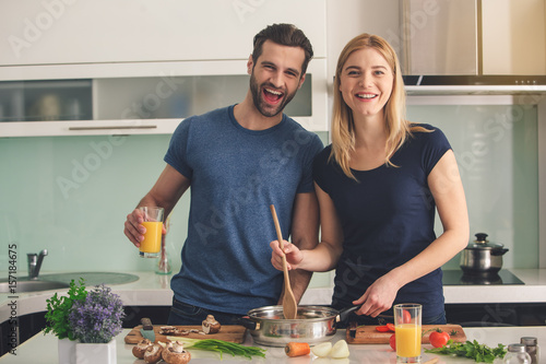 Young couple cooking together meal preparation indoor