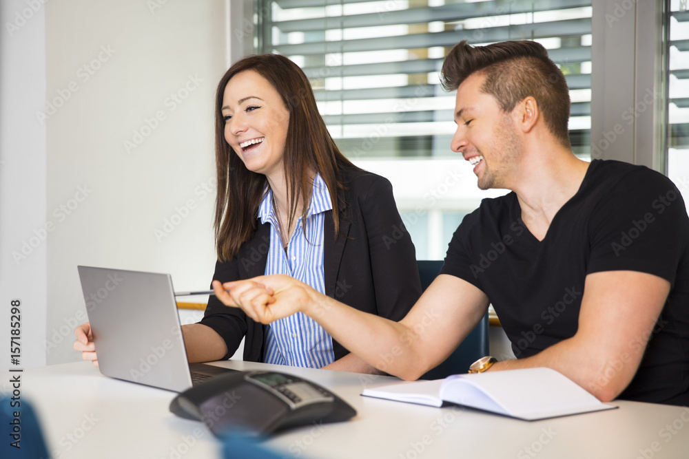 Smiling Business People With Laptop Communicating At Desk Smiling Business People With Laptop Communicating At Desk