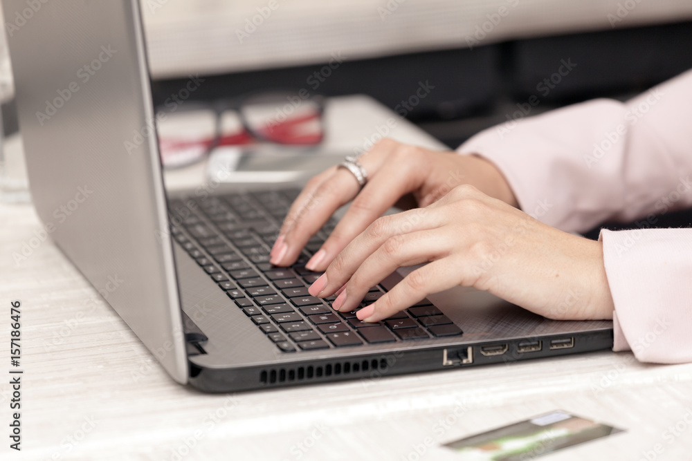Close-up of typing female hands on keyboard, she surfs the internet and buying on line Close-up of typing female hands on keyboard, she surfs the internet and buying on line