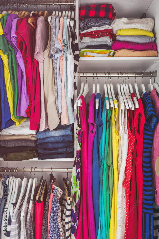 Fotografia do Stock: Home closet bedroom clean wardrobe of women fashion  clothing hanging on racks. Woman clothes.
