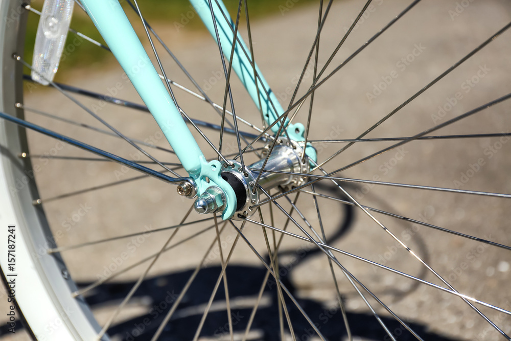 Closeup view of bicycle wheel spokes on blurred background