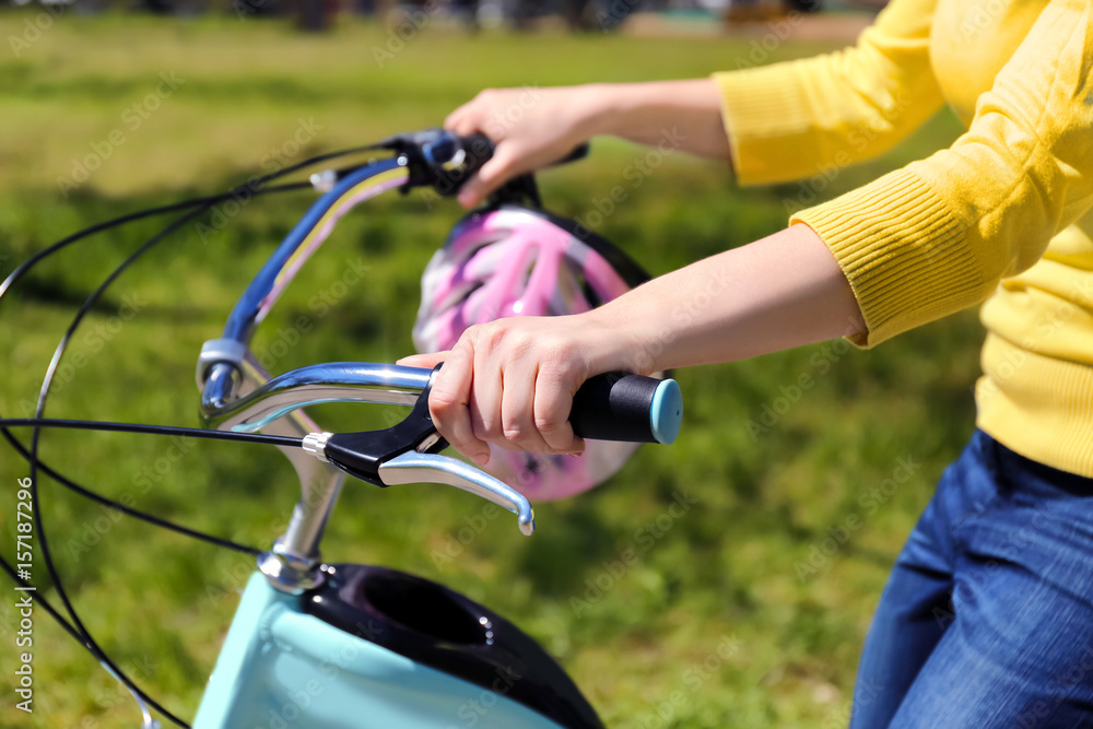 Young woman riding bike in park on sunny day Young woman riding bike in park on sunny day