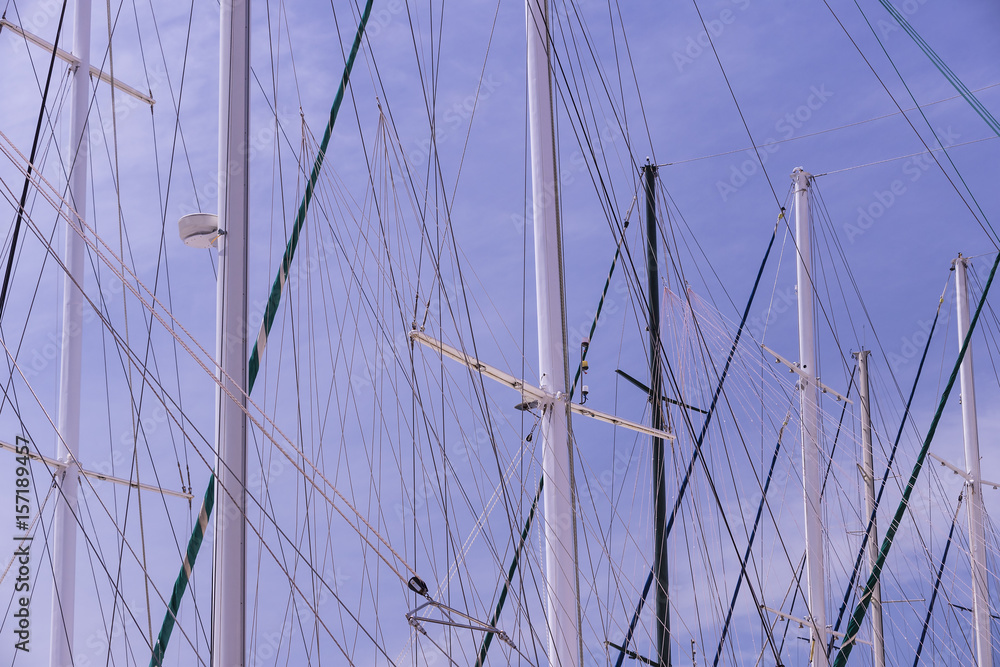 Masts of ships and sailboats against the sky Masts of ships and sailboats against the sky
