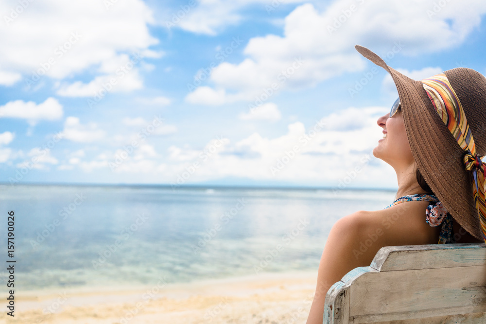 woman tourist relaxing in deck chair at beach in vacation woman tourist relaxing in deck chair at beach in vacation