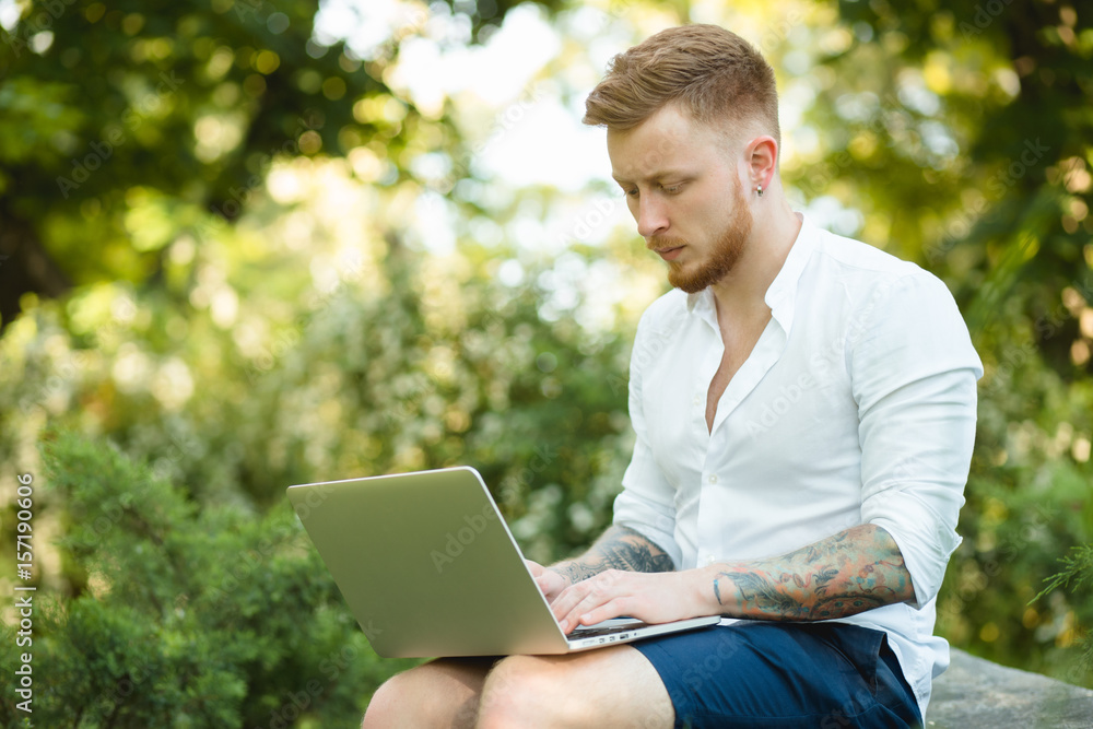 Man freelancer working with laptop in a nature Man freelancer working with laptop in a nature