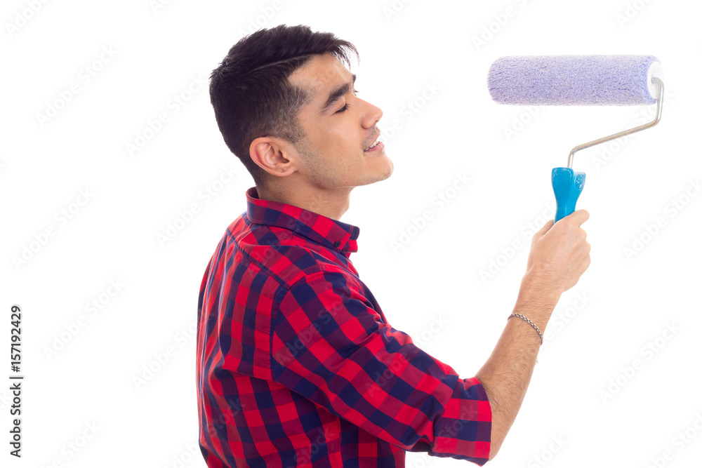 Young man using blue roll Young man using blue roll