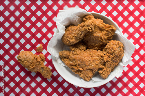 Fried chicken on red checkerboard tablecloth photo