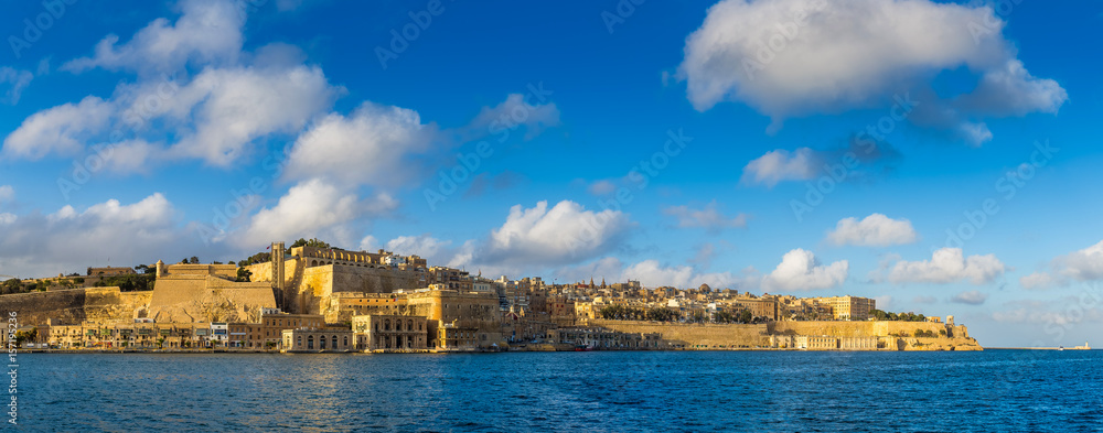 Valletta, Malta - Panoramic skyline view of the capital city of Malta with Grand Harbor and blue sky with clouds