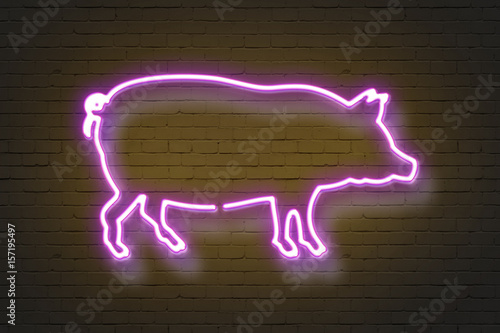 Pig, neon sign on brick wall