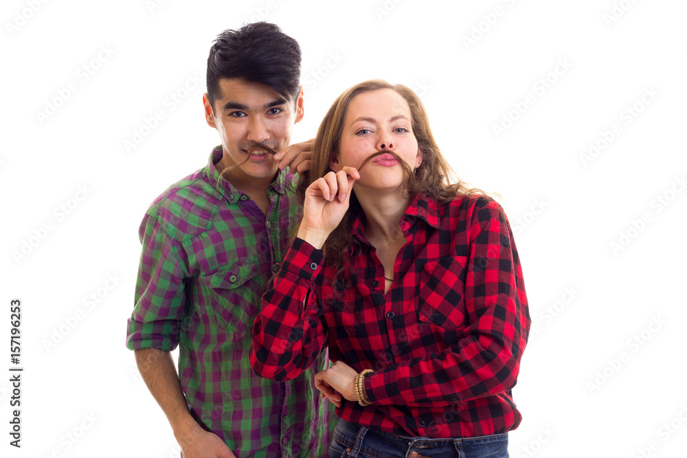 Young couple in plaid shirts with moustache of hair Young couple in plaid shirts with moustache of hair
